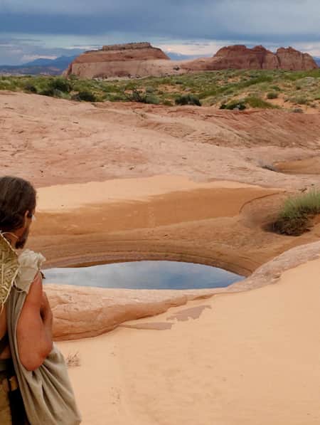 A man hiking through the desert.