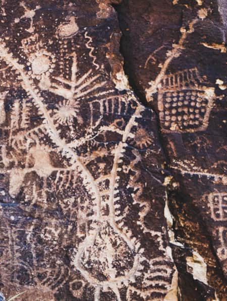A close-up view of petroglyphs etched into the surface of a rock.