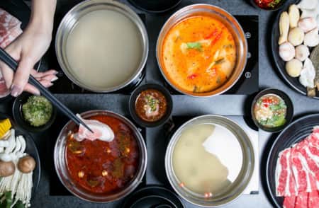 Top view of a table set with various shared dishes.