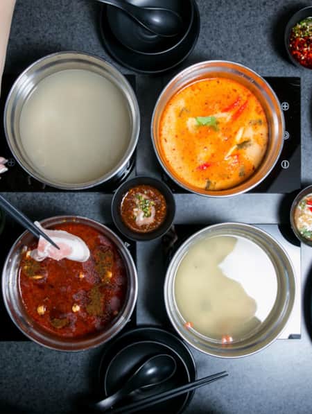 Top view of a table set with various shared dishes.