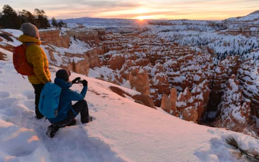 See red rock hoodoos coated with a dusting of snow on an unforgettable winter visit to Bryce Canyon National Park.