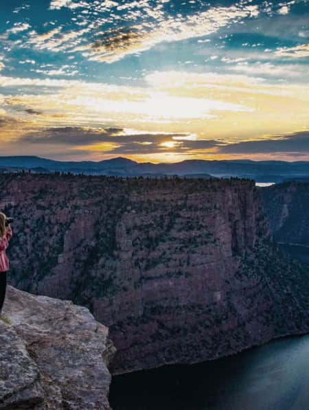 Woman taking a picture along the Canyon Rim Trail at Flaming Gorge.