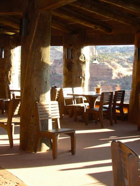 Scenic view from a restaurant patio overlooking a canyon with red and white striated rock.