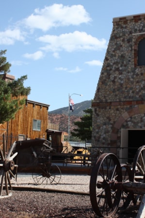 Vintage wagons staged in front of an old stone building.