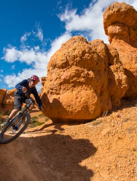 Mountain biker on a trail at Thunder Mountain, smiling and making a quick turn.