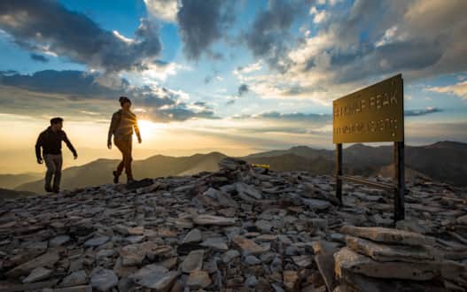 Hikers reaching the summit of Mount Belknap.