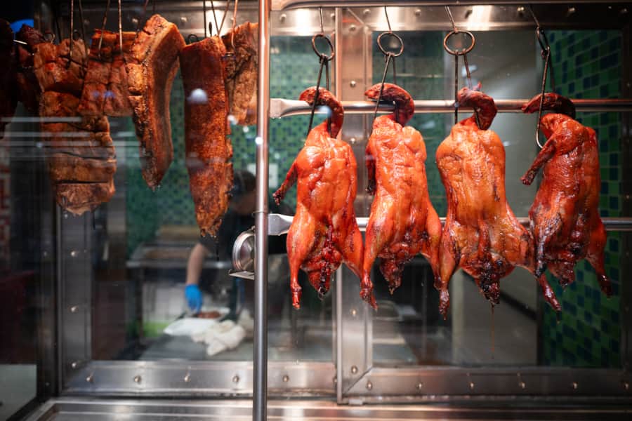 Roast duck on display among the prepared foods.