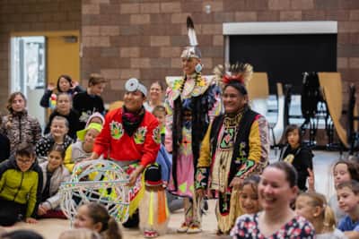 In 2017, Patrick Willie (pictured left) launched a service project for Native American Heritage Month, volunteering to present free dance performances at local schools.