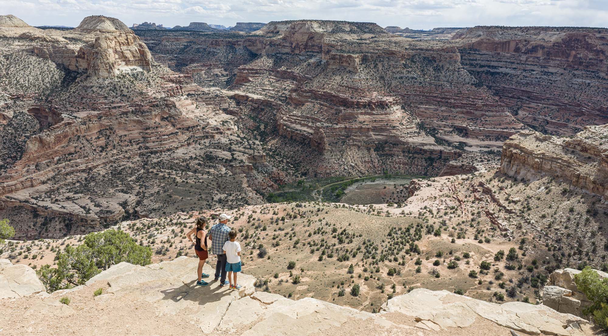 Taking in the “Little Grand Canyon” from The Wedge Overlook. The drive-up viewpoint allows a sky-high view all the way down to the San Rafael River thousands of feet below. A trail network for hikers and bikers follows the cliff top.