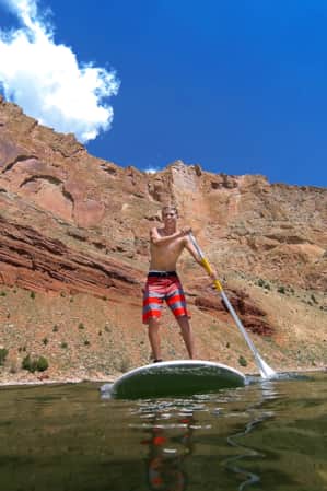 Young person stand up paddle boarding at Sheep Creek.