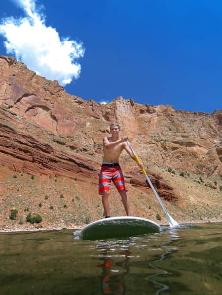 Young person stand up paddle boarding at Sheep Creek.