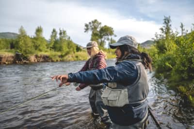 Nicole Cordingley learning from Rebeca Reyes Granillo, Owner and Lead Guide of Immerse Fly Fishing, on the Middle Provo River in Heber, UT.
