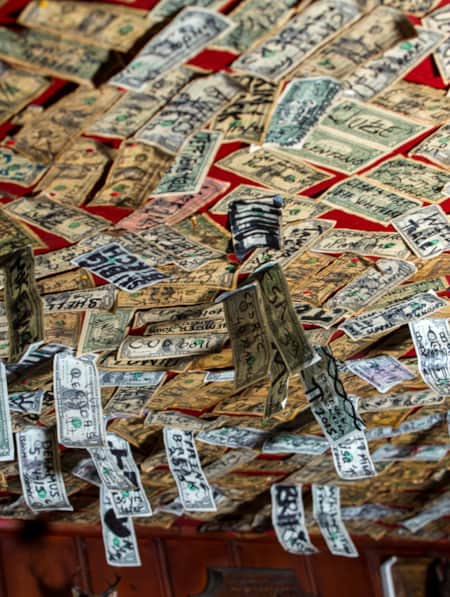 Dollar bills hanging from the ceiling of the Shooting Star Saloon.
