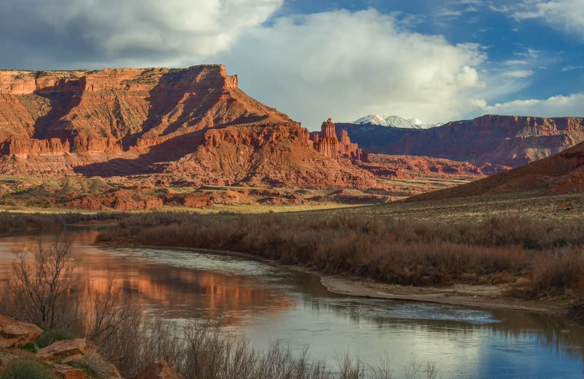 Fisher Towers framed by the La Sal Mountains and the Colorado River.