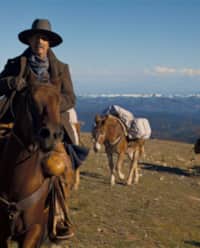 Kevin Costner rides a horse across a Southern Utah mountain range in the film, "Horizon: An American Saga."