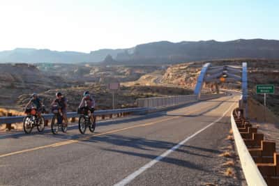 Bikers passing over the Hite Crossing Bridge.