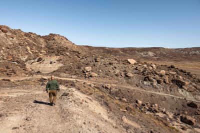 Descending the Dalton Wells Quarry Trail (left), one of the shade structures along the Utahraptor Historic Trail (right).