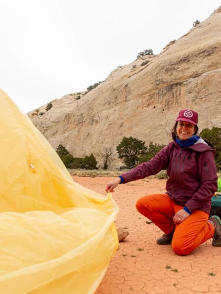 Two backpackers setting up a camping tent.