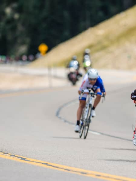 A group of cyclists racing on the road.