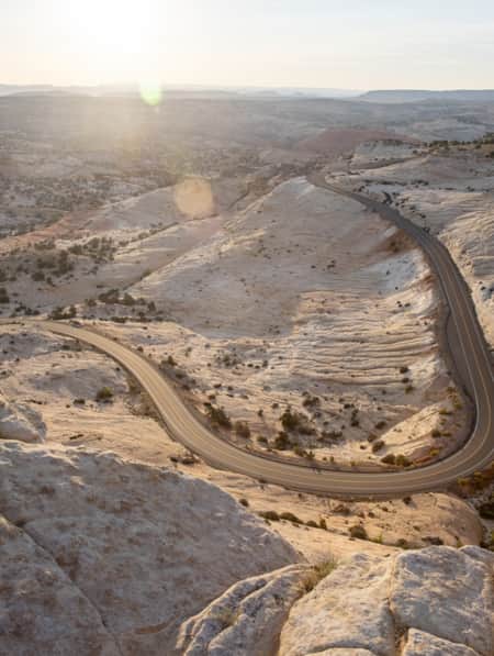A road winding through white sandstone hills.