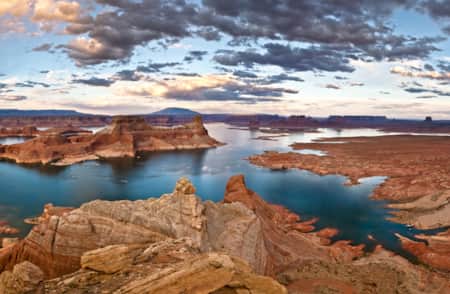 Aerial view of a reservoir surrounded by red rock formations.