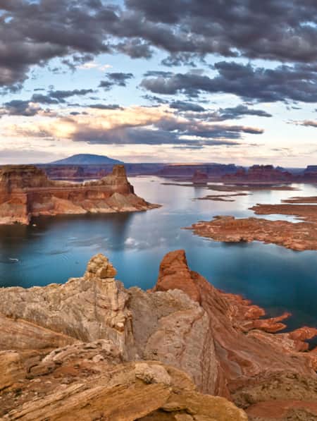 Aerial view of a reservoir surrounded by red rock formations.