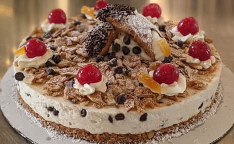 The cannolo cake incorporates all the best elements of a traditional cannoli with sweetened ricotta cream base, broken cannoli shells and chocolate chips.