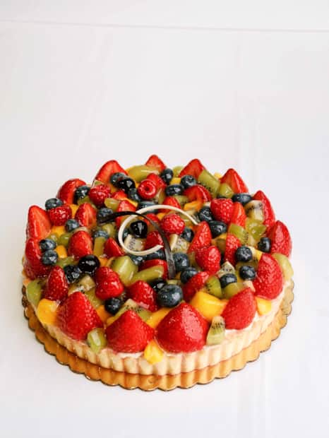 Their vibrant tart cake is filled with mascarpone crémeux and topped with a medley of fresh, seasonal fruit and a sweet apricot glaze.
