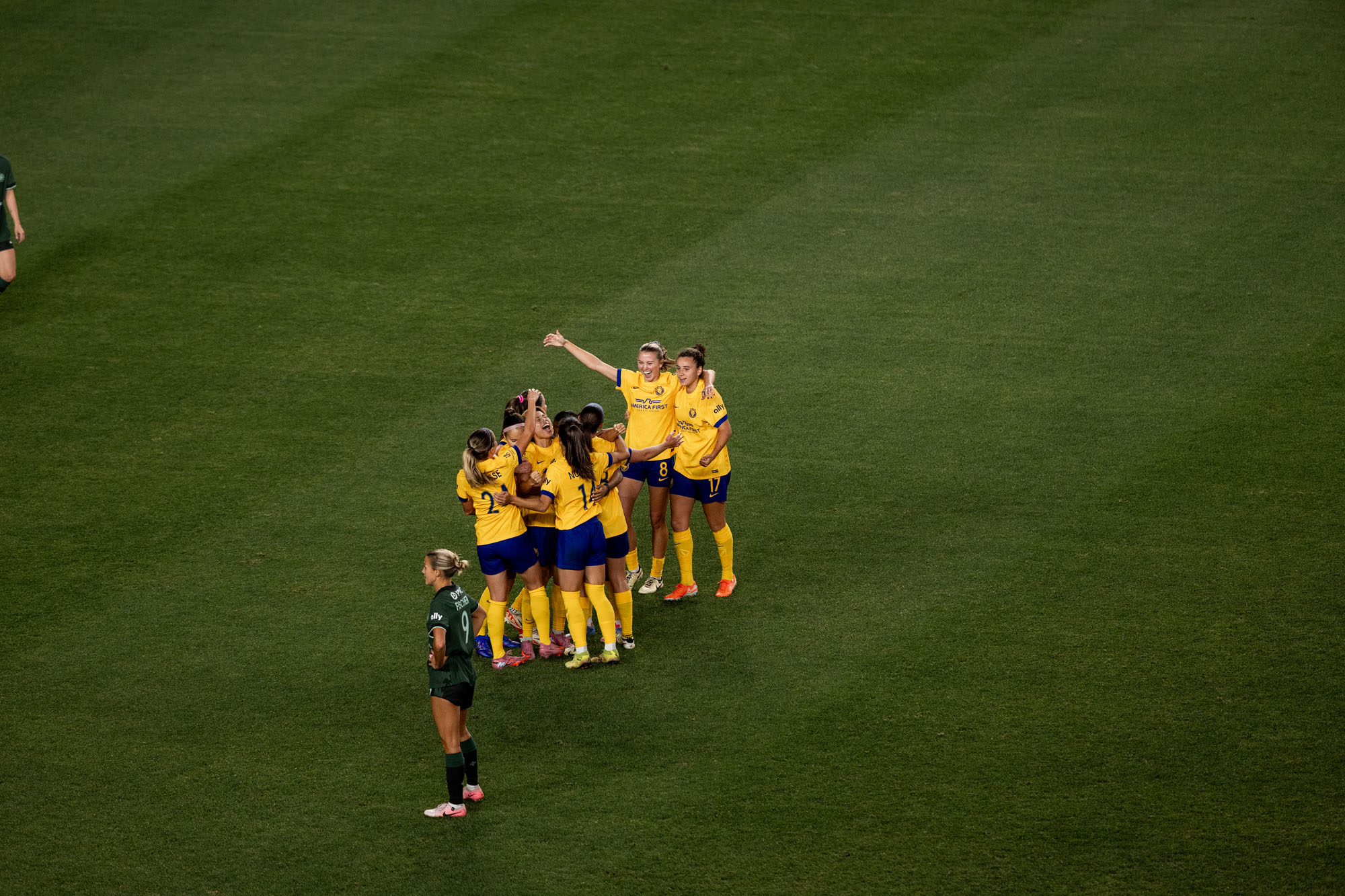 Utah Royals players celebrate a play on the field. 