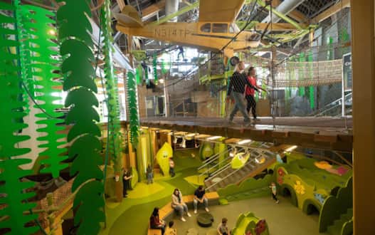 The whimsical and colorful Rainbow Bridge in the Museum of Natural Curiosity provides an imaginative structure that invites exploration and playful adventures.