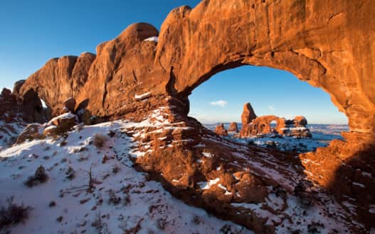 Arches National Park's famous red rock under a light dusting of snow.