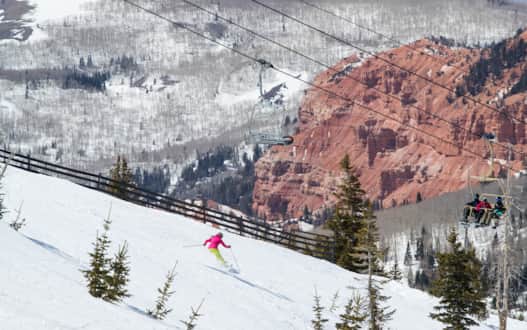 Surrounded by contrasting evergreen spruce and aspen, Brian Head Resort also showcases snow-dusted red rock hoodoos.
