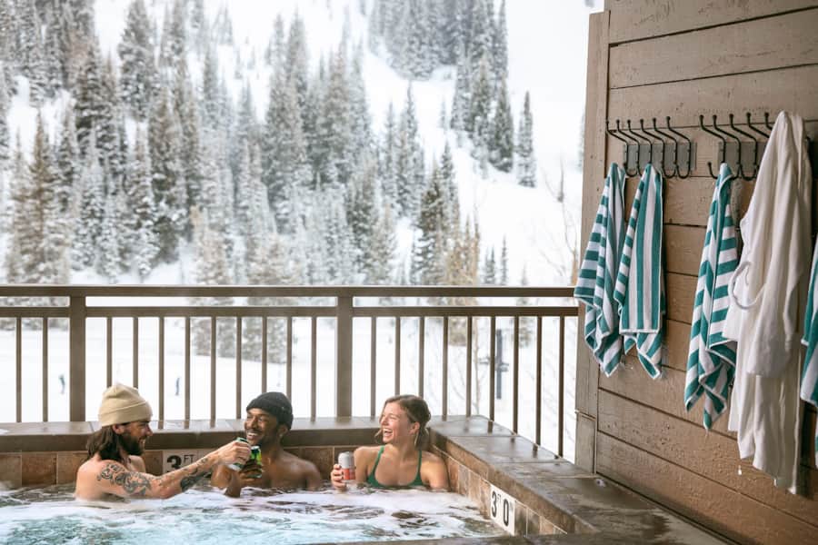 Soak in the hot tub at Snowpine Lodge surrounded by stunning mountain views.