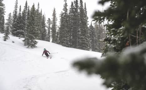 Melissa Fields skiing powder near the Castle Peak Yurt.
