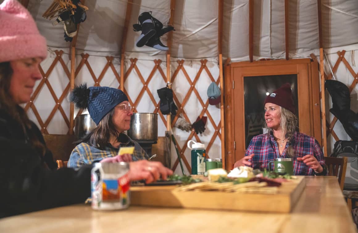 The group recounts stories from the day's ski adventure.