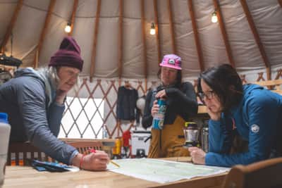 The group discusses the route plan for a day of ski touring.
