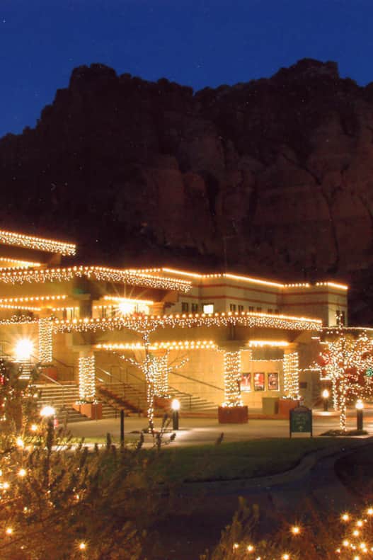Experience the spirit of Christmas with lights under the red rock cliffs at the Tuacahn Center for the Arts.
