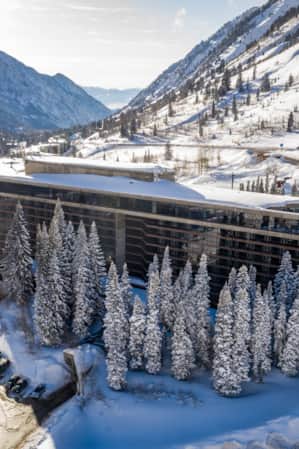 A hotel nestled in the mountains, covered in snow.
