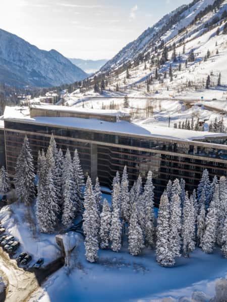 A hotel nestled in the mountains, covered in snow.