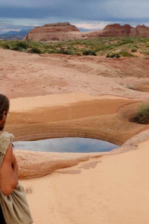 A man hiking through the desert.