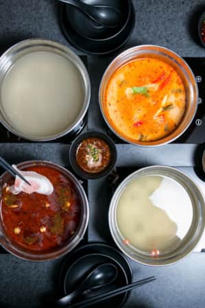Top view of a table set with various shared dishes.