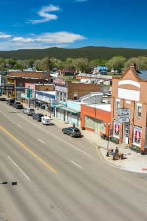Aerial view of a historic downtown street, showcasing the layout of buildings, roads, and architectural details from above.
