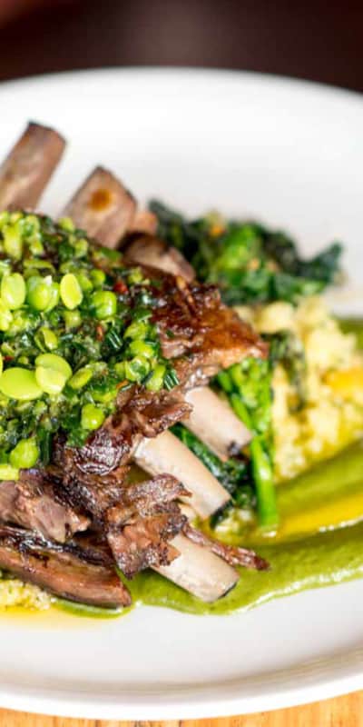 Lamb Riblets with pistachio tahini, apricot couscous, fava bean gremolata, and rapini from The Copper Onion.