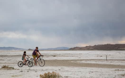Tim and Juliet ride the "playa," the dry bed north shoreline of Great Salt Lake near Kosmo, a point on the BLM's Transcontinental Railroad Backcountry Byway.