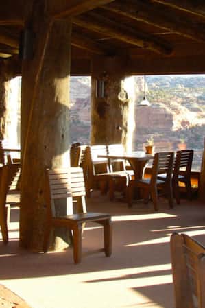 Scenic view from a restaurant patio overlooking a canyon with red and white striated rock.