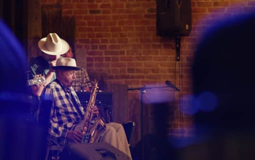 Blues meets jazz. Wheeler accompanies 98-year-old saxophone legend Joe McQueen at the Lighthouse Lounge in Ogden. McQueen is what we might call a "living legend," but that barely does him justice — and Wheeler knows this. He says with good reason McQueen is not nostalgic about the past. Rejecting nostalgia might be why at 98 years old he remains as sharp as ever. He plays upward of 10 shows a month (including a monthly show at the Garage on Beck in Salt Lake City) and continues to make history with the raw material that ties their stories together: music.