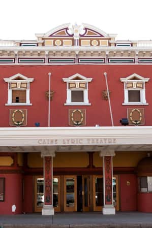A historical building with decorative finishes, featuring the name 'Caine Lyric Theatre'.