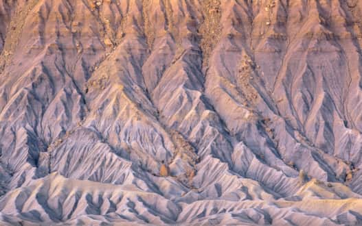 Factory Butte glows pastel purple at sunrise, which is something you have to see to believe.