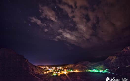 Helper City under the dark night sky.