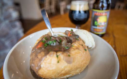 A bread bowl filled with beef stew.